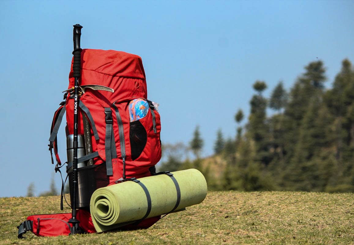 Camino de Santiago packing list Backpack with trekking poles and water bottle for el Camino pilgrimage