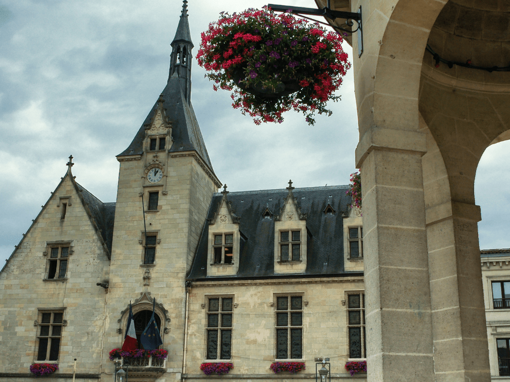 stone building with high clock tower
