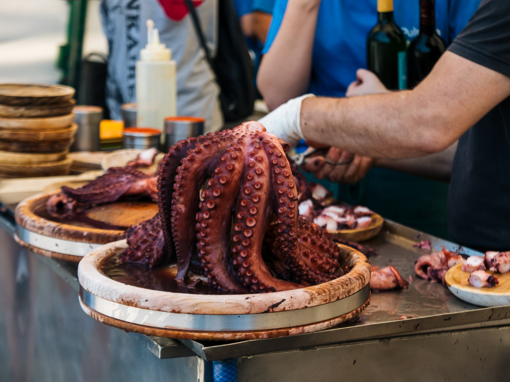 hands preparing Galician octopus