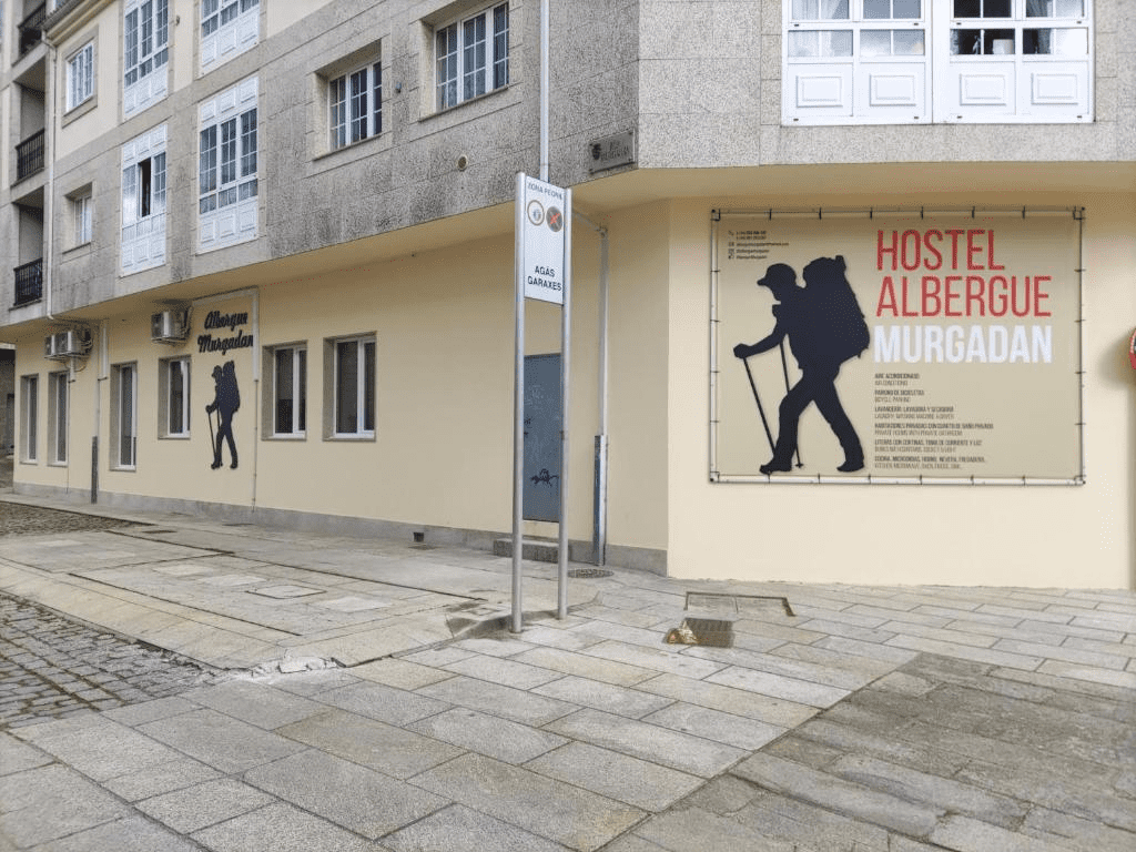 exterior of albergue building with pilgrim painted on it