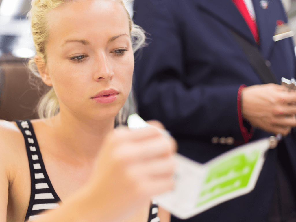 Woman showing train ticket to conductor