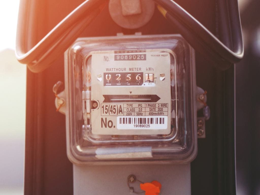 an electric meter during golden hour reading watts per hour