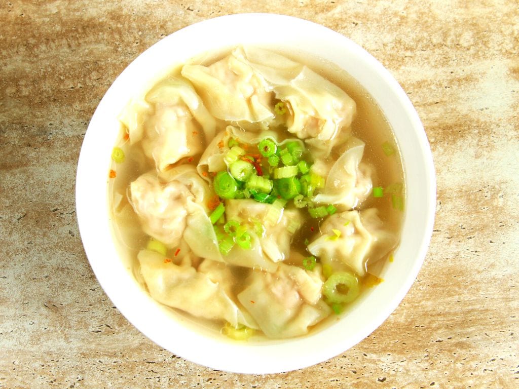 a bowl on wonton soup from the top